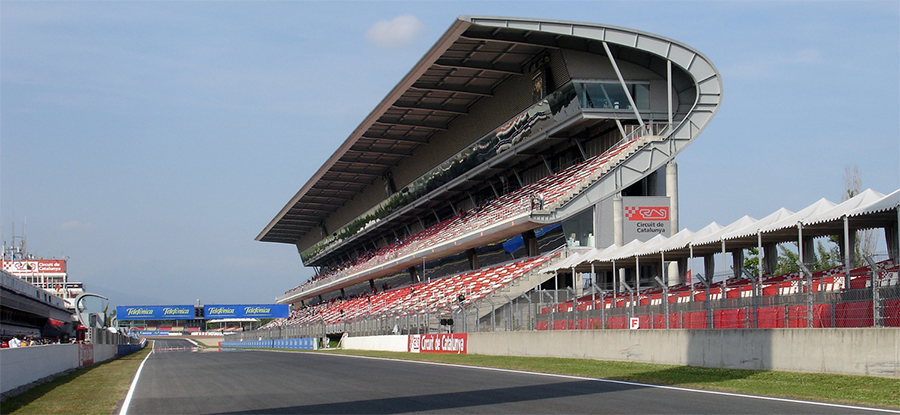 "A photo of a grandstand next to a straightaway of a race track."