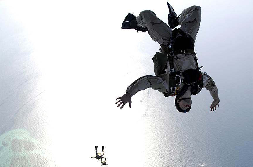 "Two skydivers free falling in the sky."